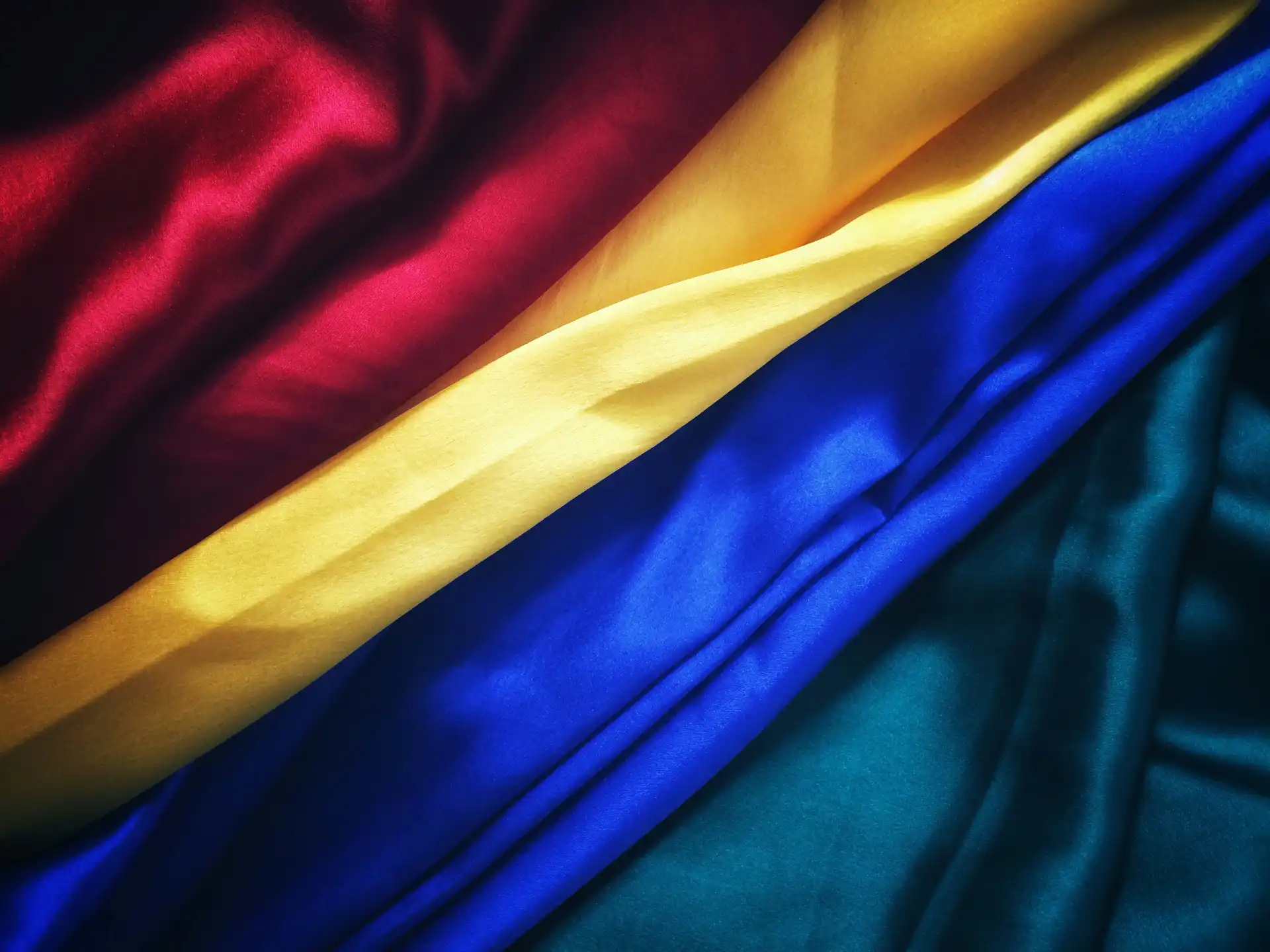 Close-up of colorful nylon fabric showcasing the richness of red, yellow, blue, and green textures