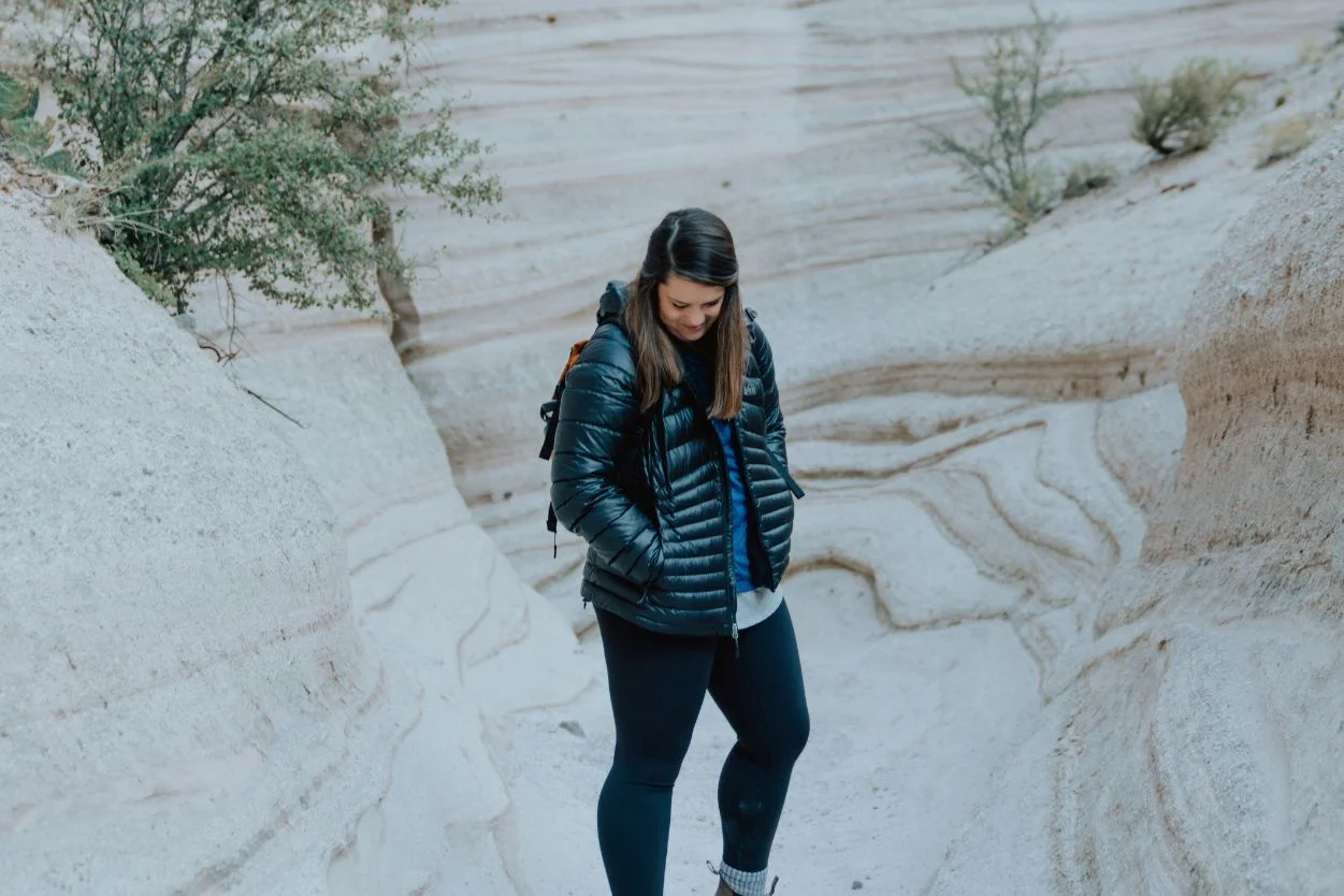 Woman wearing a black puffer jacket, perfect for cold weather adventures and outdoor exploration.