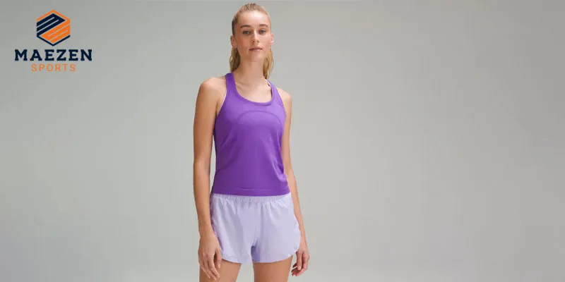 "Female model in a purple tank top and white shorts from Maezen Sports, showcasing stylish and comfortable athletic wear, ideal for active lifestyles."