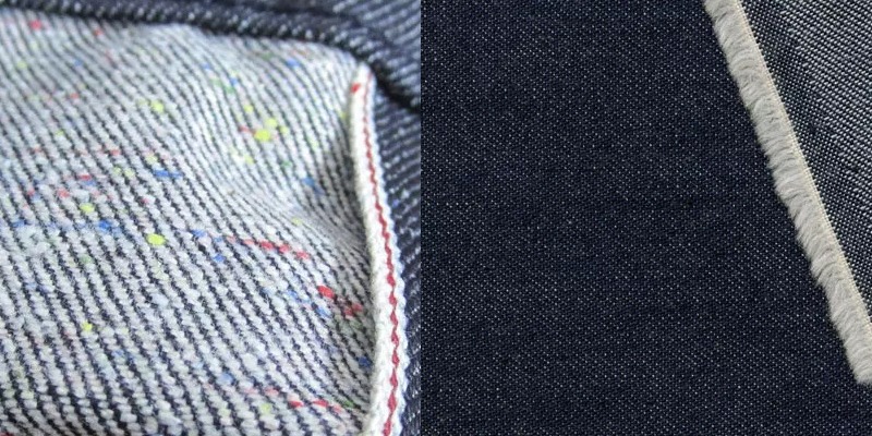Close-up comparison of two types of twill fabric: the left side shows a lighter-colored twill with colored specks and a visible selvedge edge, while the right side shows a dark indigo twill with a clean, straight selvedge