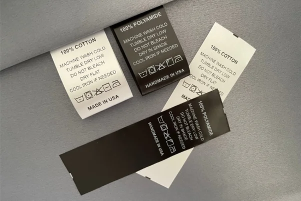 Clothing Care Tags on Black Fabric