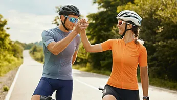 two cycling player giving high five