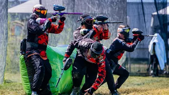 A paintball team playing in the field